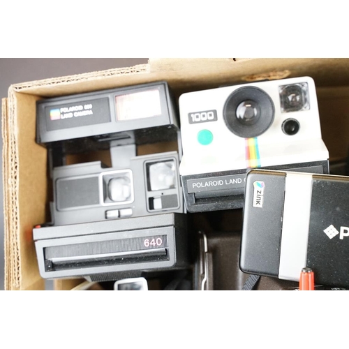 409 - A large collection of Polaroid Instant cameras to include a Polaroid 600, Impulse and various SX-70 ... 