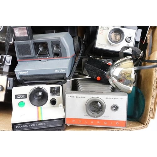 409 - A large collection of Polaroid Instant cameras to include a Polaroid 600, Impulse and various SX-70 ... 