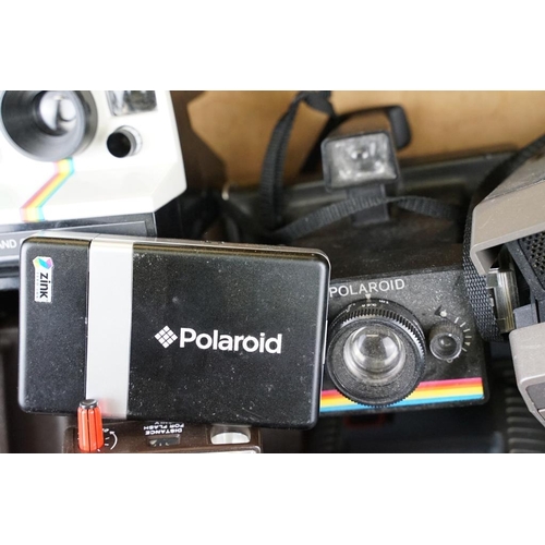 409 - A large collection of Polaroid Instant cameras to include a Polaroid 600, Impulse and various SX-70 ... 