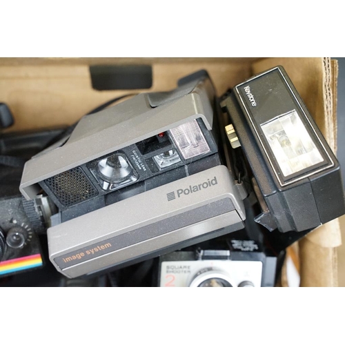 409 - A large collection of Polaroid Instant cameras to include a Polaroid 600, Impulse and various SX-70 ... 