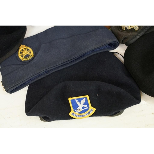 413 - Collection of 20 military caps and berets with associated badges to include Serbia Air Force, Vietna... 