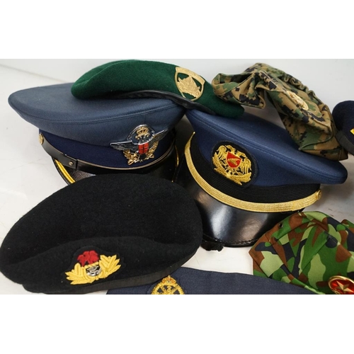 413 - Collection of 20 military caps and berets with associated badges to include Serbia Air Force, Vietna... 