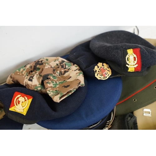 413 - Collection of 20 military caps and berets with associated badges to include Serbia Air Force, Vietna... 