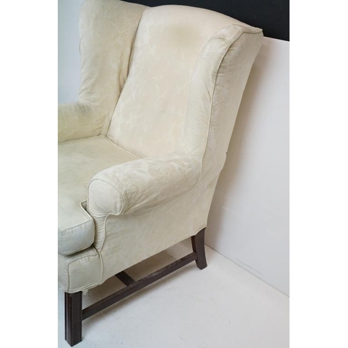 623 - Georgian style Wing Back Armchair with cream upholstery and H-stretcher, 84cm wide x 88cm deep x 106... 