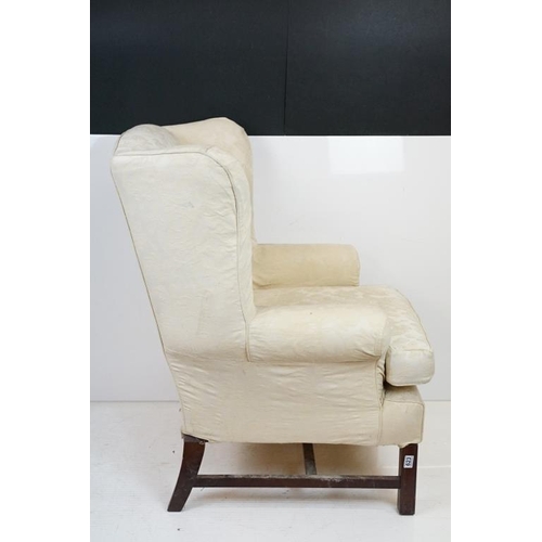 623 - Georgian style Wing Back Armchair with cream upholstery and H-stretcher, 84cm wide x 88cm deep x 106... 