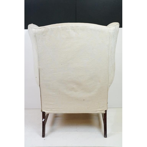 623 - Georgian style Wing Back Armchair with cream upholstery and H-stretcher, 84cm wide x 88cm deep x 106... 