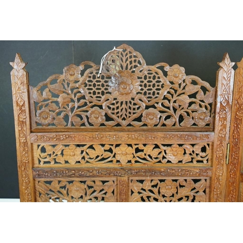 637 - Indian Hardwood four-fold Dressing Screen with profuse pierced floral carving throughout, each panel... 