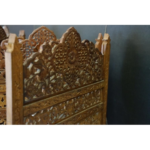 637 - Indian Hardwood four-fold Dressing Screen with profuse pierced floral carving throughout, each panel... 