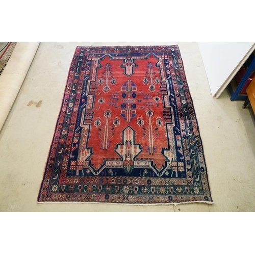 578 - Persian Wool Rug, the red ground with a geometric pattern within a border, 238cm x 160cm