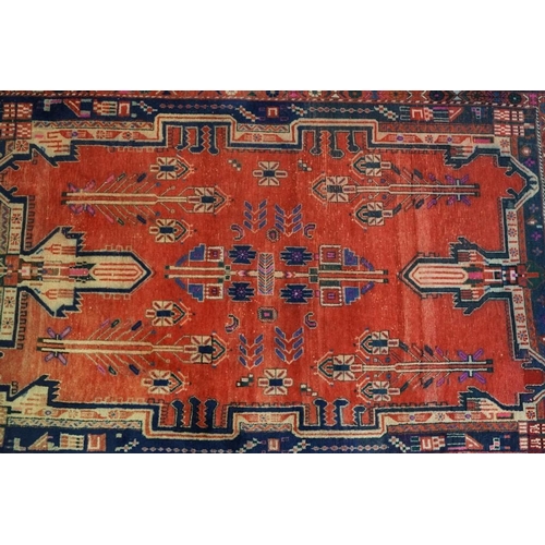 578 - Persian Wool Rug, the red ground with a geometric pattern within a border, 238cm x 160cm