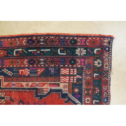 578 - Persian Wool Rug, the red ground with a geometric pattern within a border, 238cm x 160cm