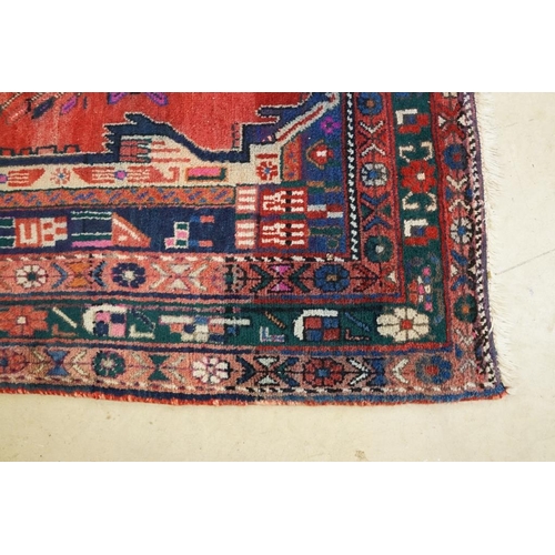 578 - Persian Wool Rug, the red ground with a geometric pattern within a border, 238cm x 160cm