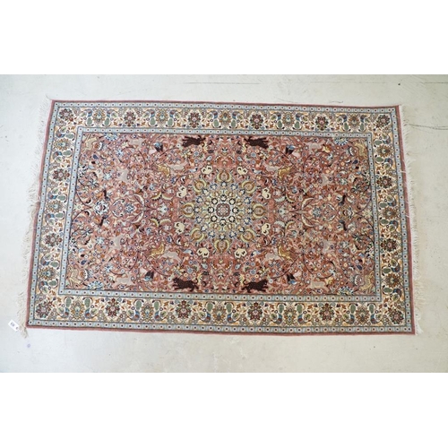 636 - Persian style Rug, the pink ground with a pattern of stylised hunting big cats and deer with birds a... 