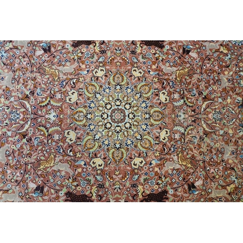 636 - Persian style Rug, the pink ground with a pattern of stylised hunting big cats and deer with birds a... 