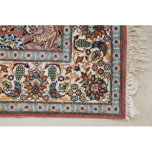 636 - Persian style Rug, the pink ground with a pattern of stylised hunting big cats and deer with birds a... 