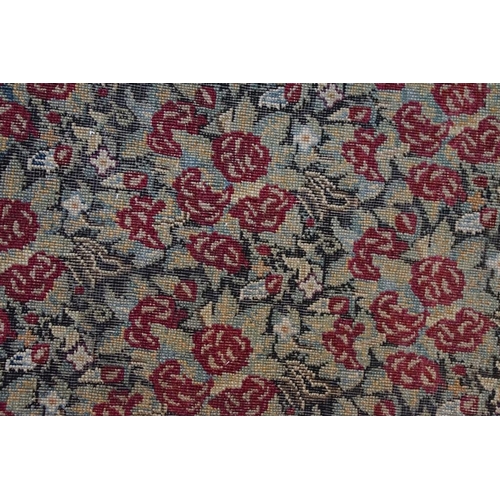 640 - Kerman Rug with all-over red roses, flowers and leaves, highlights of indigo, the border with entwin... 