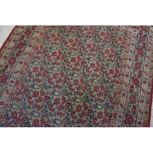 640 - Kerman Rug with all-over red roses, flowers and leaves, highlights of indigo, the border with entwin... 