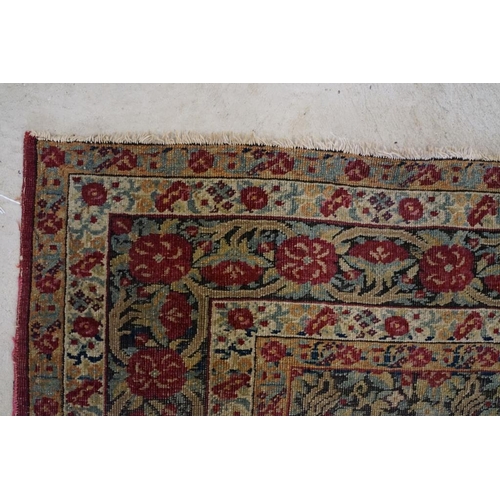 640 - Kerman Rug with all-over red roses, flowers and leaves, highlights of indigo, the border with entwin... 