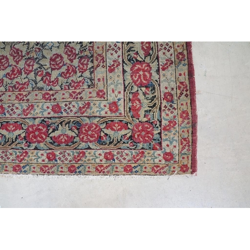 640 - Kerman Rug with all-over red roses, flowers and leaves, highlights of indigo, the border with entwin... 