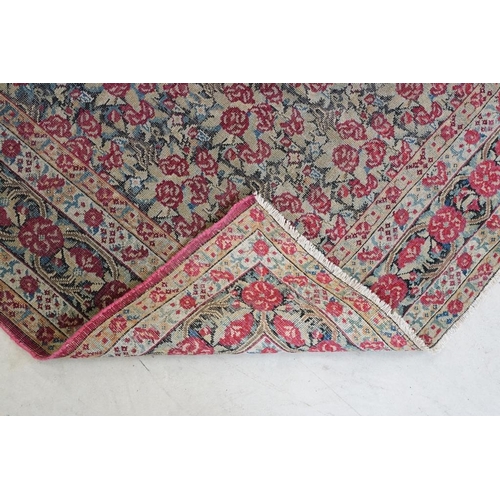 640 - Kerman Rug with all-over red roses, flowers and leaves, highlights of indigo, the border with entwin... 