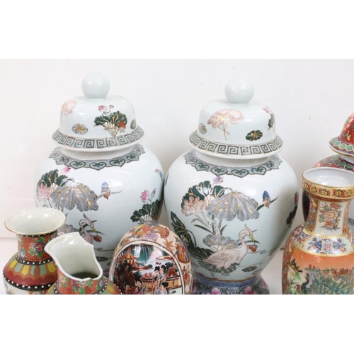 158 - Collection of oriental ceramics to include a pair of lidded vases with lotus flower detailing, assor... 