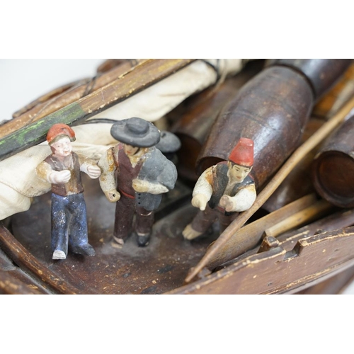 201 - Early 20th century scratch built wooden model of a Portuguese cargo boat, with painted sailor figure... 