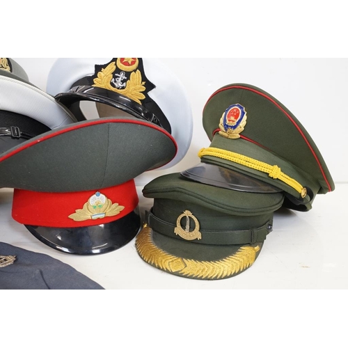 433 - A collection of ten military caps and berets together with associated badges to include Ukraine Army... 