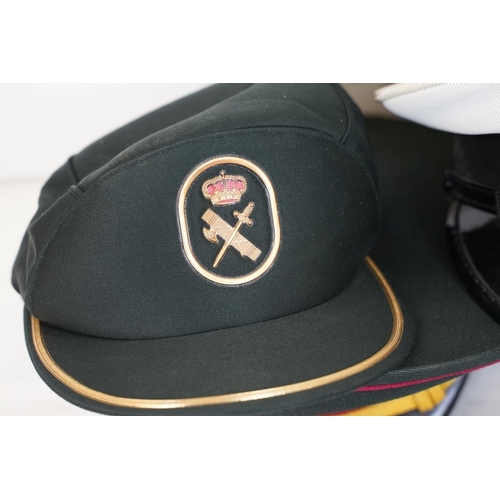 433 - A collection of ten military caps and berets together with associated badges to include Ukraine Army... 