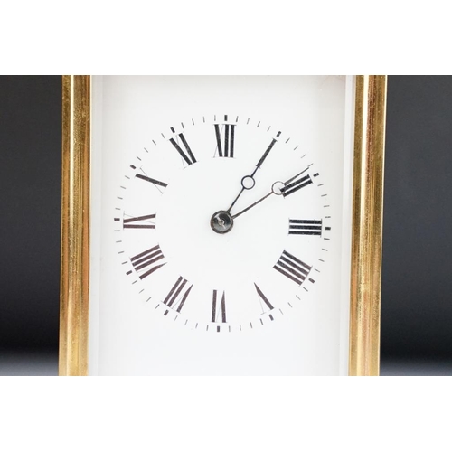 232 - A brass cased carriage clock with bevelled glass panels, with hourly repeater button to the top. App... 