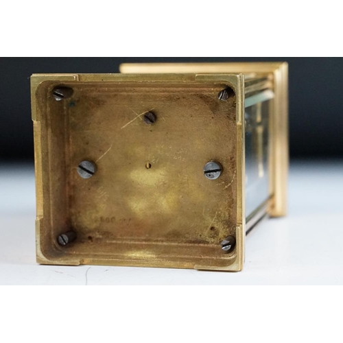 232 - A brass cased carriage clock with bevelled glass panels, with hourly repeater button to the top. App... 