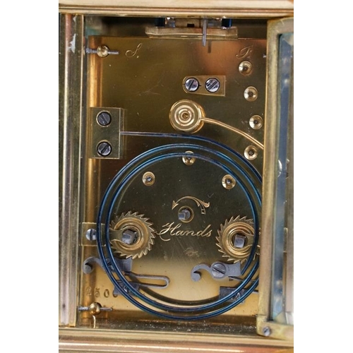 232 - A brass cased carriage clock with bevelled glass panels, with hourly repeater button to the top. App... 