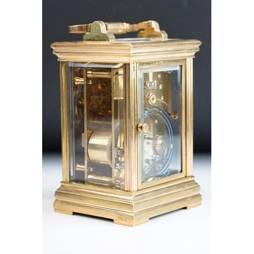 232 - A brass cased carriage clock with bevelled glass panels, with hourly repeater button to the top. App... 