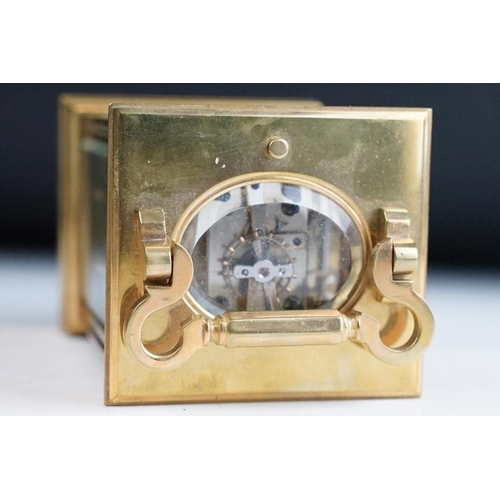 232 - A brass cased carriage clock with bevelled glass panels, with hourly repeater button to the top. App... 