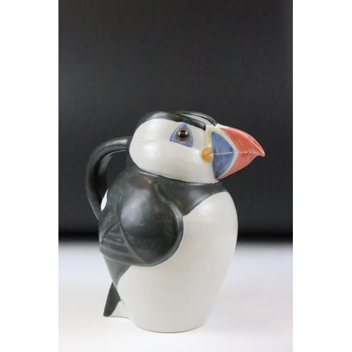 1 - Three graduating John O'Groats pottery puffin jugs. Each moulded into the form of a puffin with hand... 