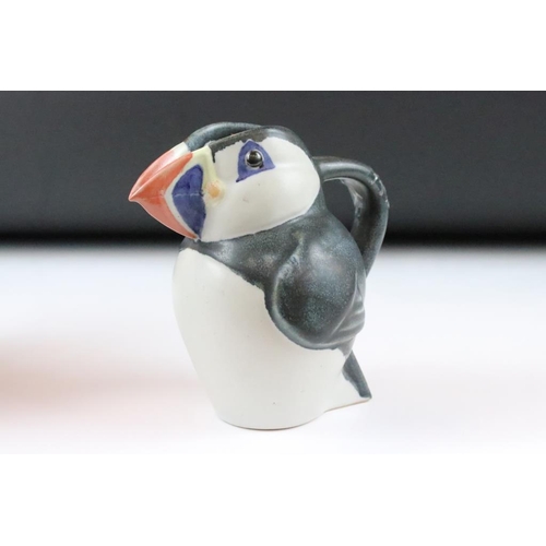 1 - Three graduating John O'Groats pottery puffin jugs. Each moulded into the form of a puffin with hand... 