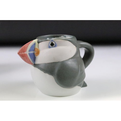 1 - Three graduating John O'Groats pottery puffin jugs. Each moulded into the form of a puffin with hand... 