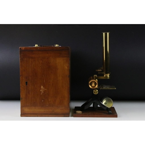 118 - An antique brass microscope within original fitted wooden case.