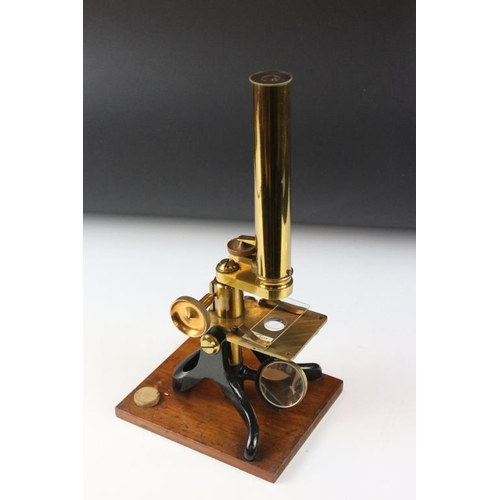 118 - An antique brass microscope within original fitted wooden case.