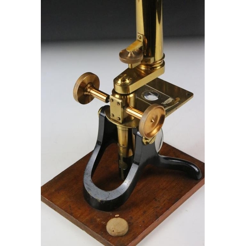 118 - An antique brass microscope within original fitted wooden case.