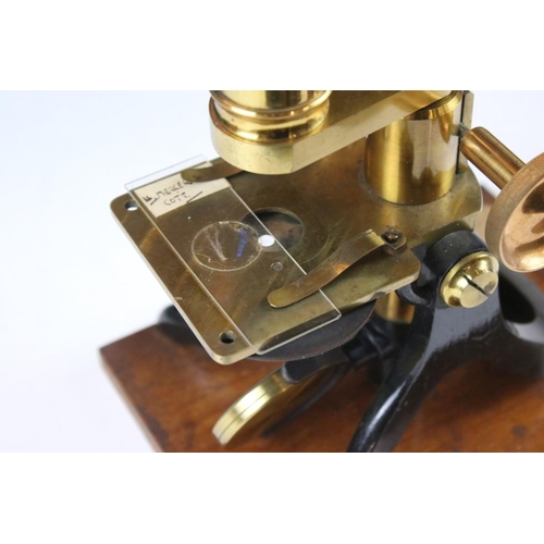 118 - An antique brass microscope within original fitted wooden case.