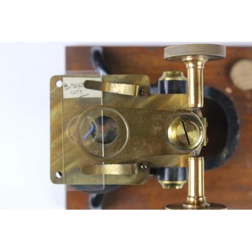 118 - An antique brass microscope within original fitted wooden case.