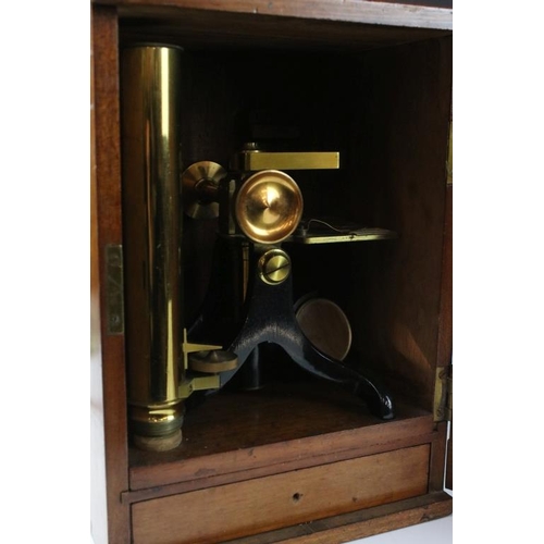 118 - An antique brass microscope within original fitted wooden case.