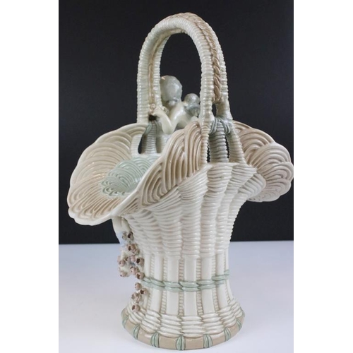 12 - Czech Amphora ceramic basket featuring two applied cherubs and floral sprays. Marked Amphora, made i... 