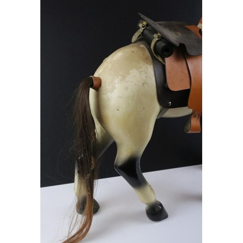 130 - Painted wooden model of a horse with mane, tail and leather saddle, approx 50cm high