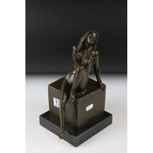 135 - Bronze figure of a nude seated female, signed 'Milo', raised on a square marble base, measures appro... 