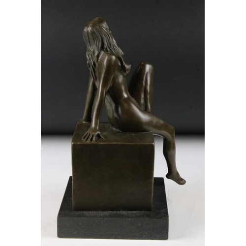 135 - Bronze figure of a nude seated female, signed 'Milo', raised on a square marble base, measures appro... 