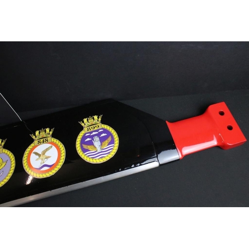 143 - Militaria - A helicopter tail rotor blade, finished in black, red and white, with applied naval air ... 