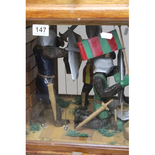 147 - Large early-to-mid 20th century automaton depicting knights fighting, with crank handle, housed with... 