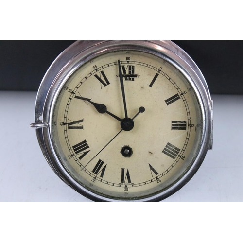 156 - Chrome bulkhead nautical ships clock, the cream dial with black Roman numerals and poker style hands... 