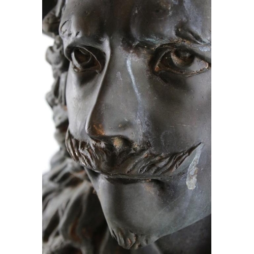 158 - Large patinated metal bust of a cavalier gentleman, raised on a square base. Measures approx 83cm hi... 